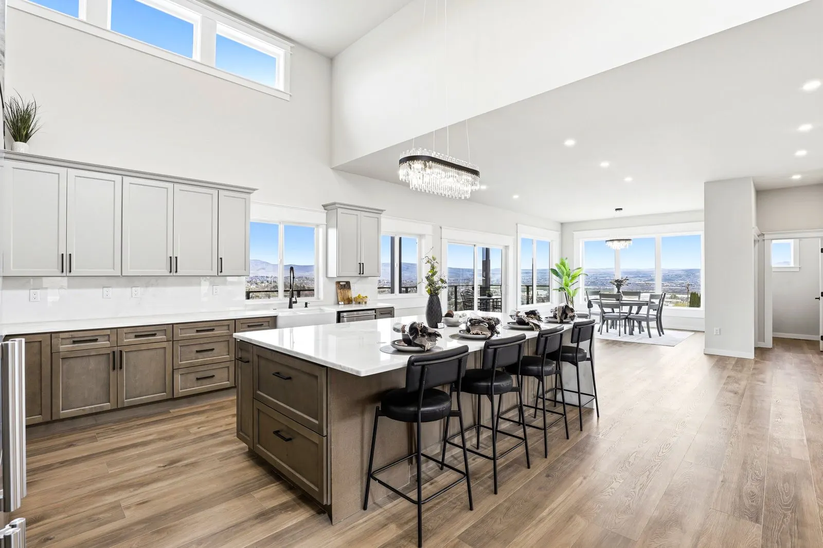 Open-concept kitchen flowing into dining and great room with valley views