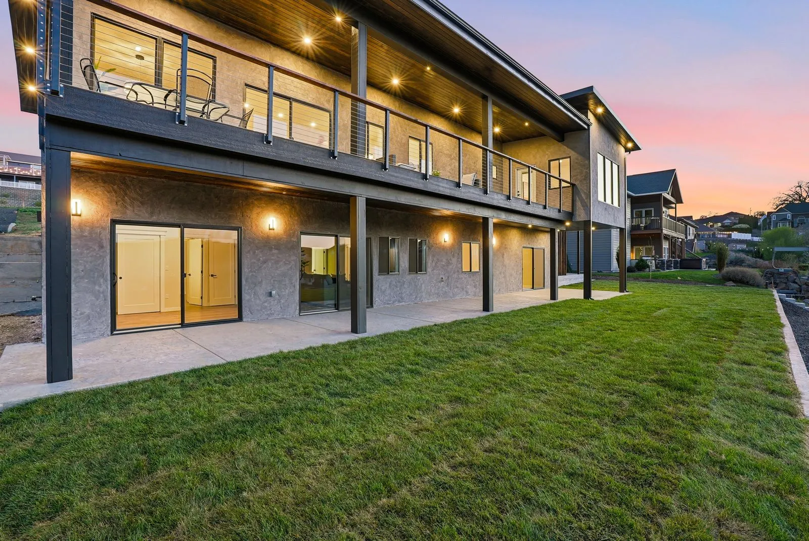 Upper terrace and lower walkout patio at twilight